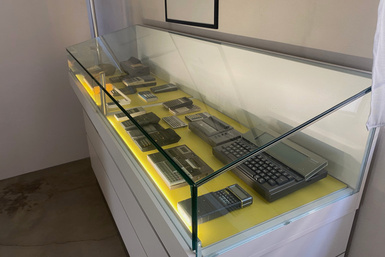 A display case containing several examples of portable electronic calculators.